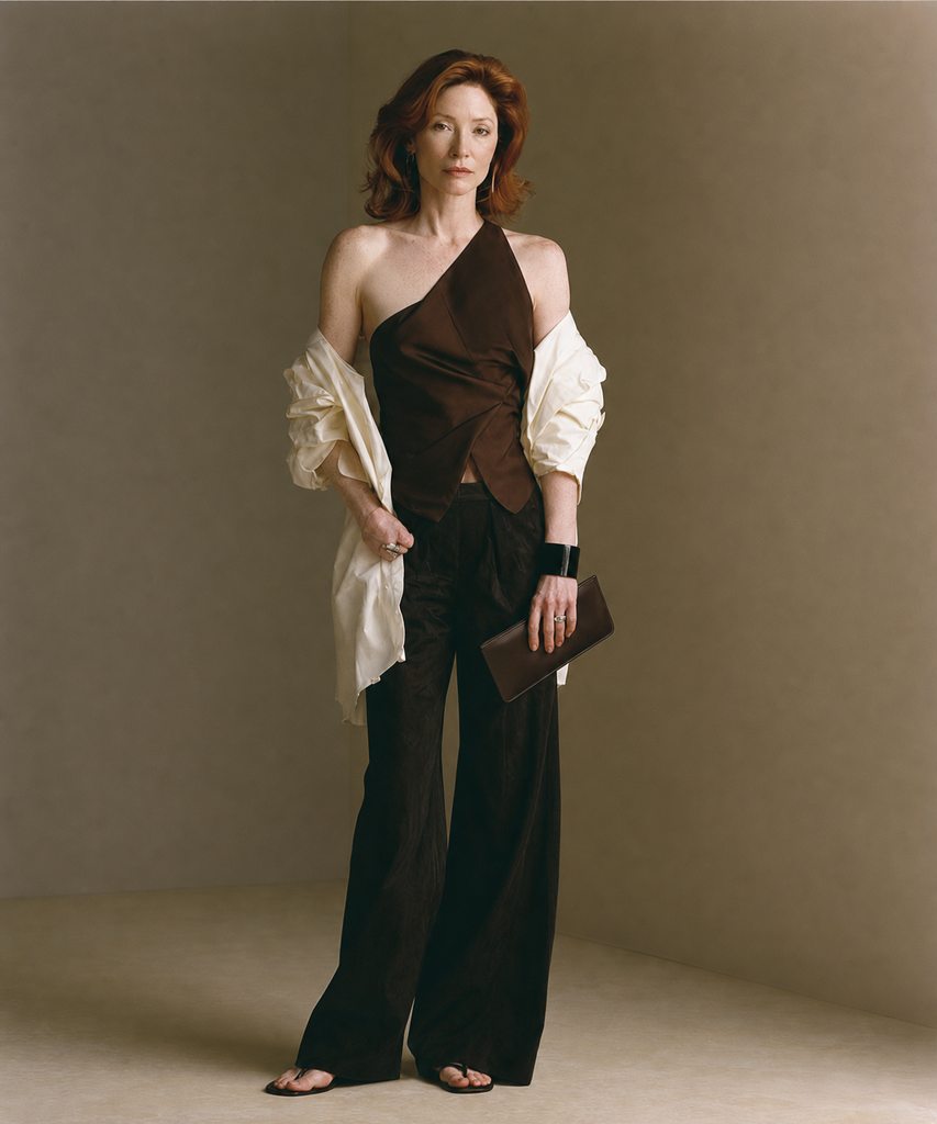 A simple dark V-neck top over a detailed, fuller bottom — an effective formula for balancing inverted triangle proportions